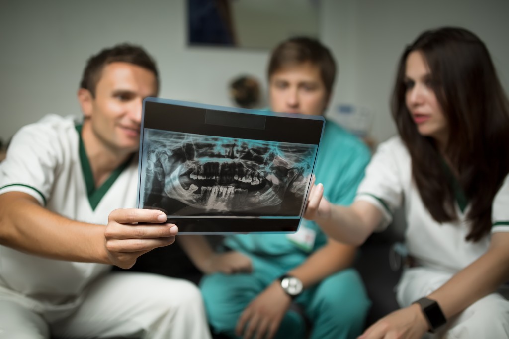 checking an x-ray of teeth