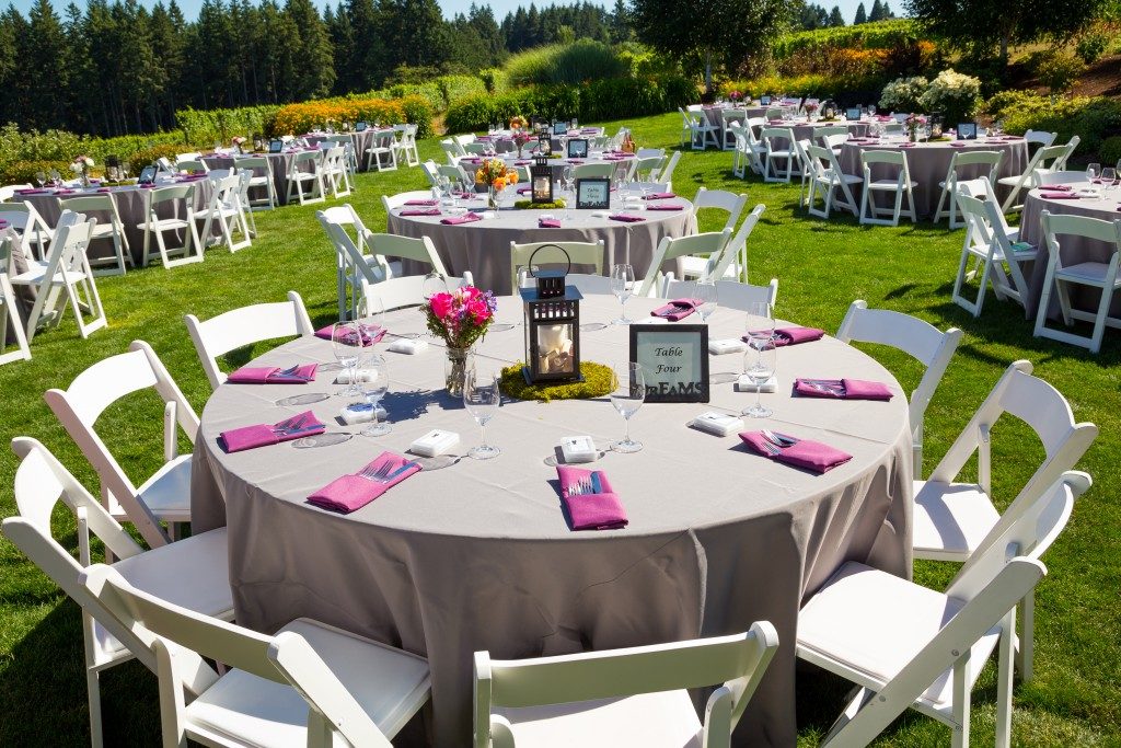 Tables, chairs, decor, and decorations at a wedding reception at an outdoor venue