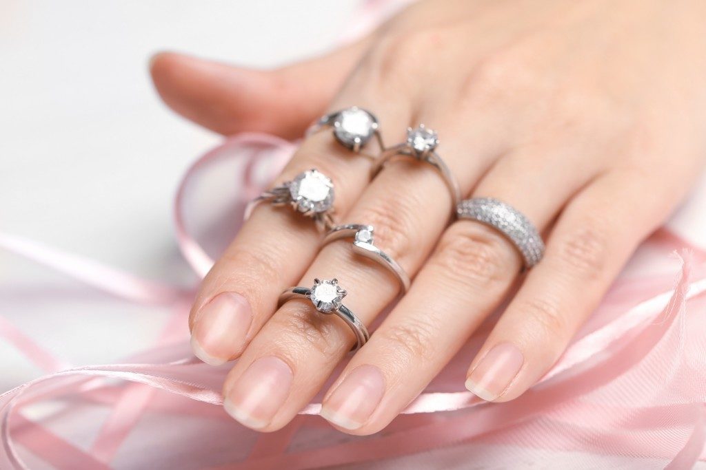 engagement rings on woman's hand