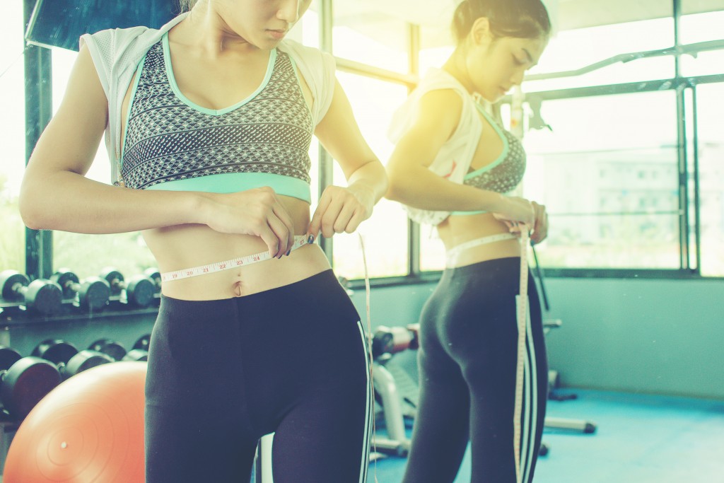 Woman checking her success in the weight loss program