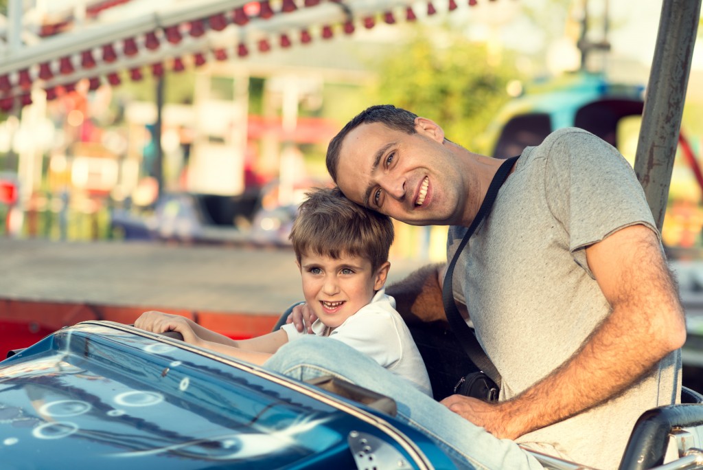 Son and father bonding in the amusement park