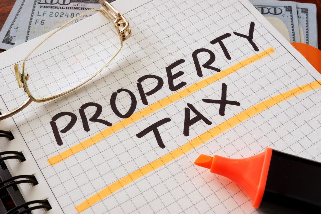 Notebook with property tax sign on a table
