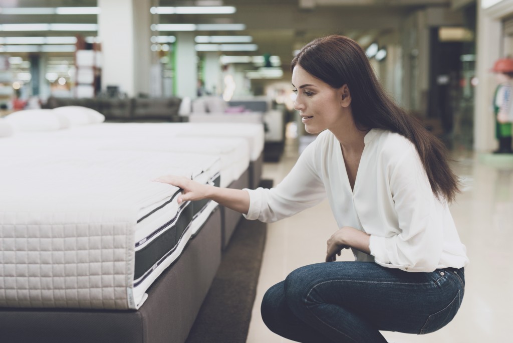 woman picking out a mattress