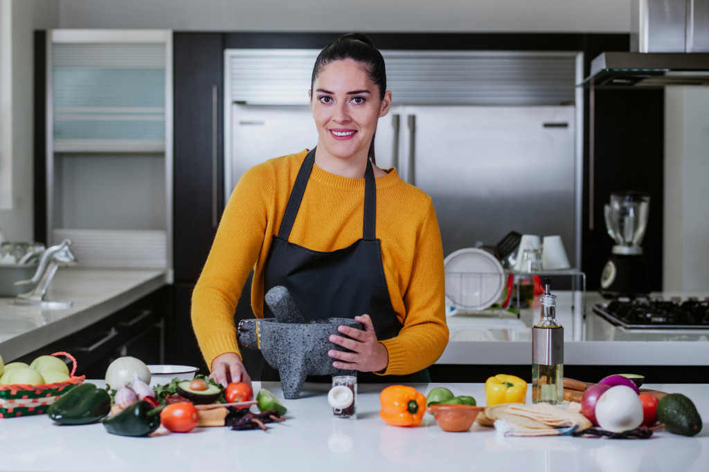 A woman cooking with healthy ingredients in the kitchen