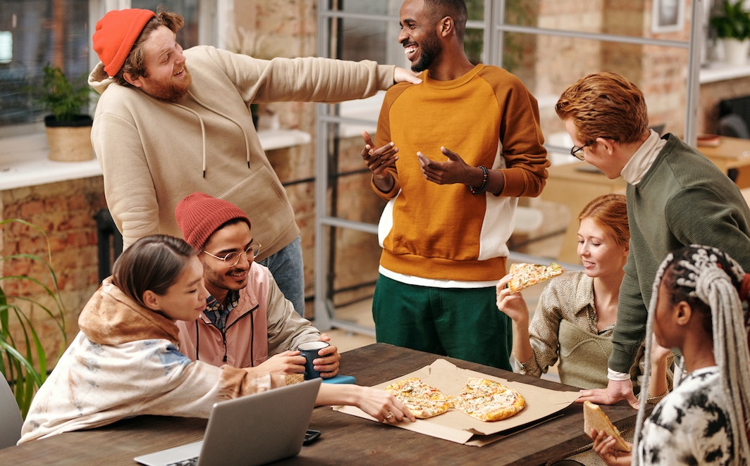 Multiracial Group of People by the Table