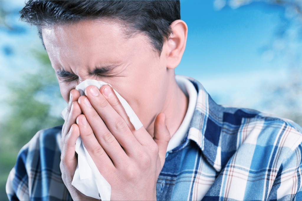 A boy coughing due to allergies