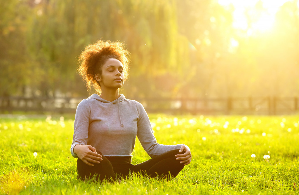 young woman meditating in nature