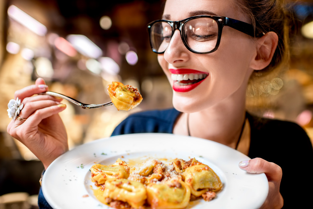 happy woman eating at a restaurant