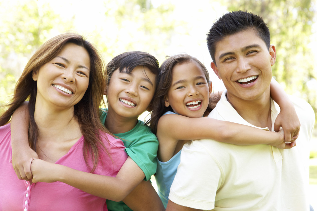 asian family of four happy and smiling outdoor