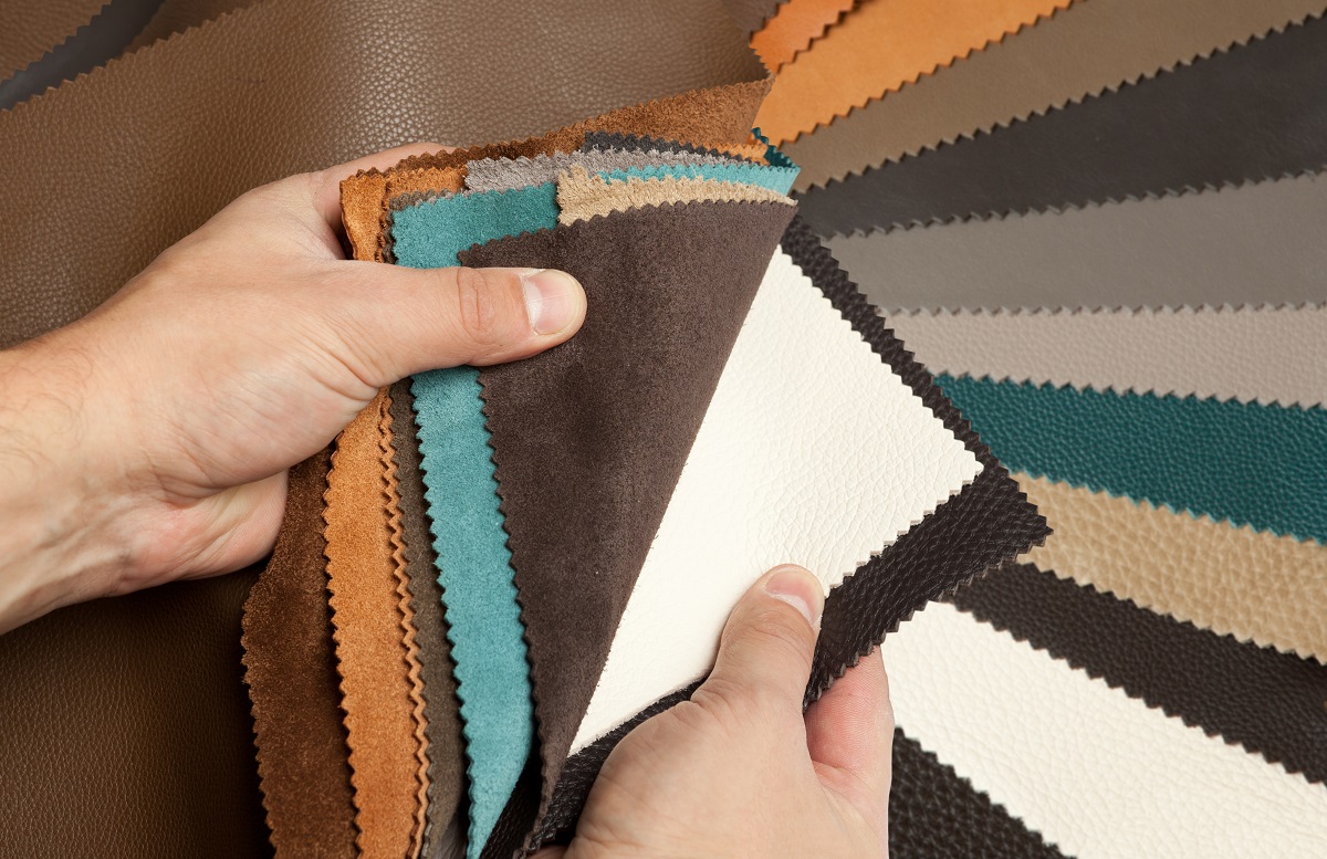 a person looking at fabrics