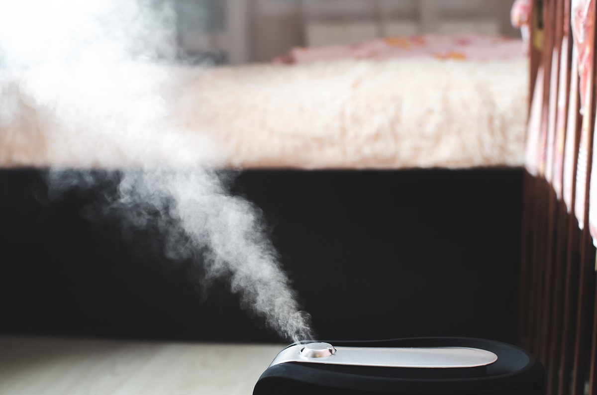 humidifier at the edge of a bed for dry skin