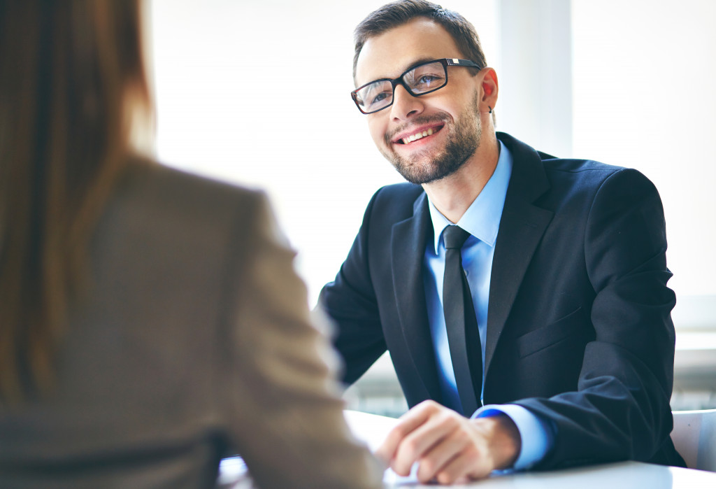 woman talking to male employer smiling