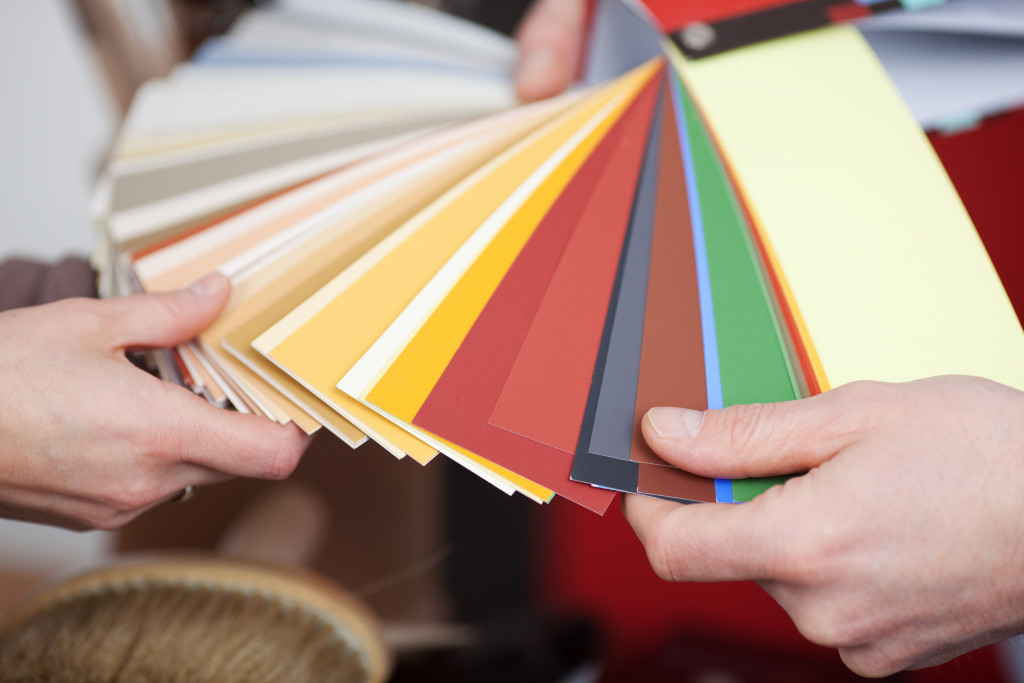 A person choosing color swatches