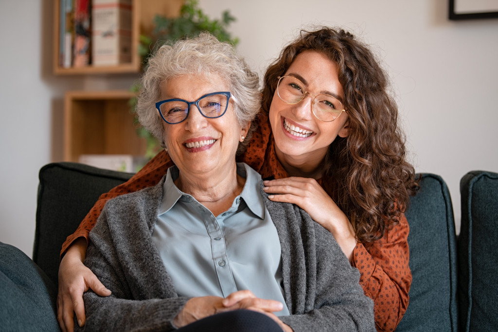 woman caring for her elderly parent smiling