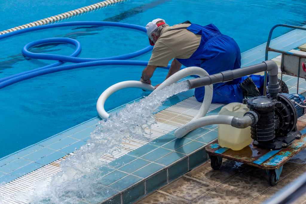 a man cleaning the pool