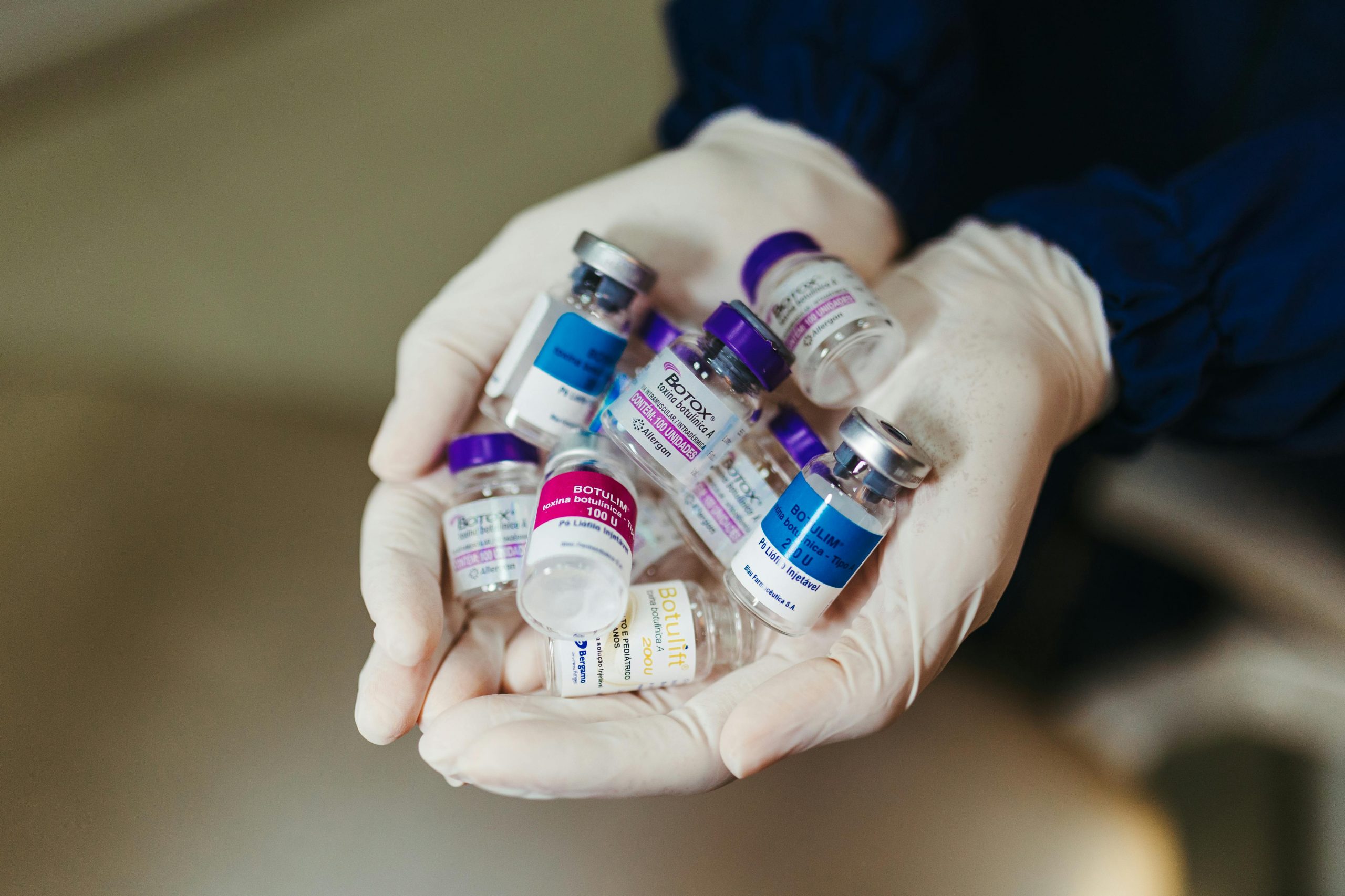 Botox vials on an aesthetician's gloved hands